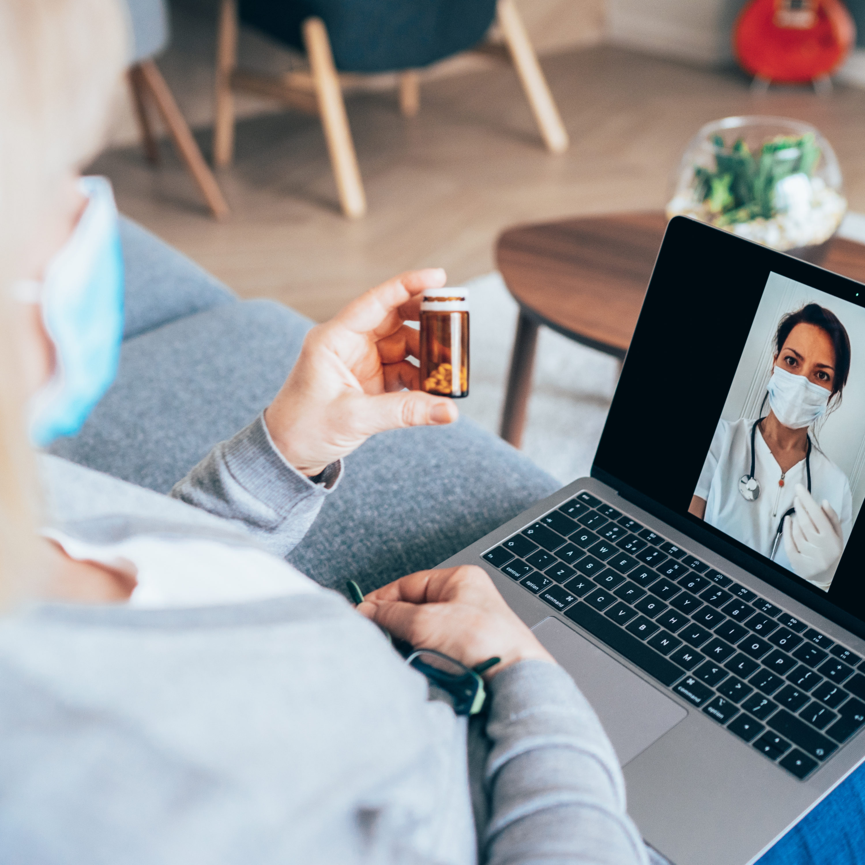 Senior woman having video call with family doctor, consulting about medicine